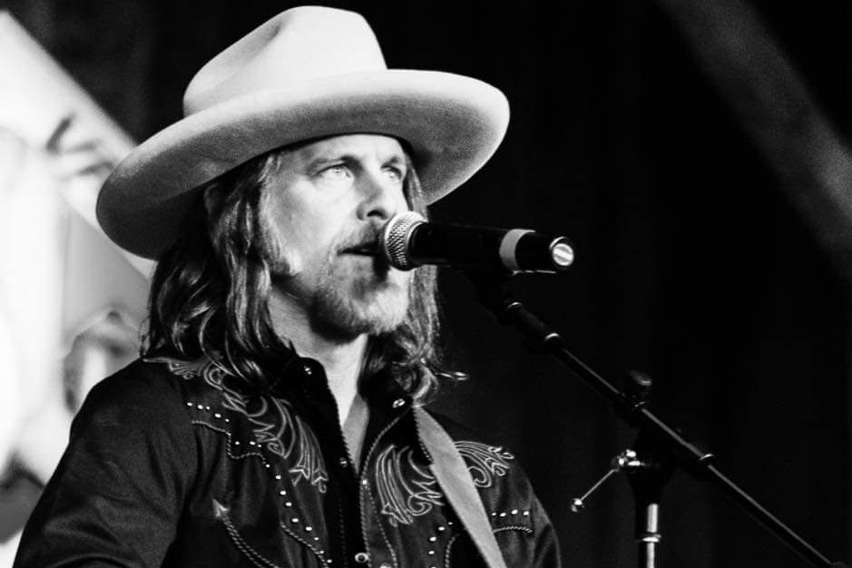 Man signing into a microphone.