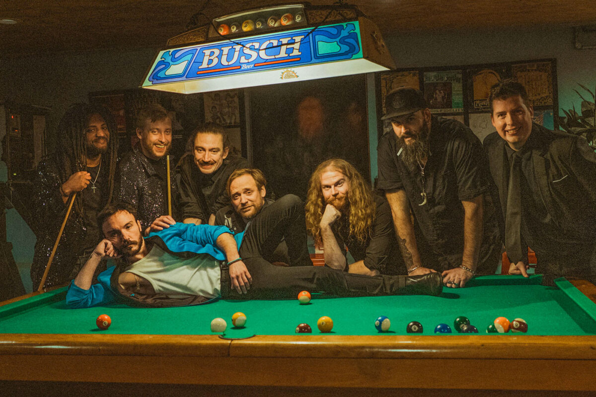 band posing on and around pool table