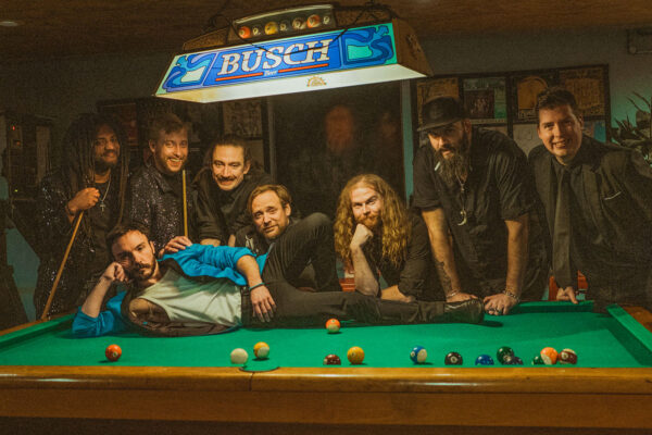 band posing on and around pool table