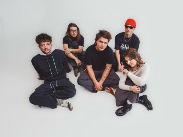 band members sitting on white background