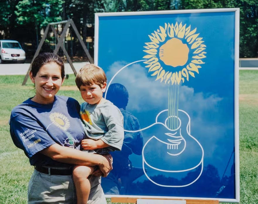 Erin and Isaac Stephens with the Master Musicians Festival artwork created by Kirby Stephens